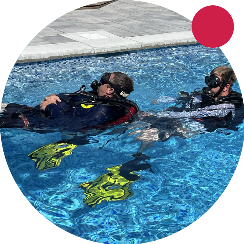 A beginner diver learning to scuba dive in a pool at Double Down Divers.