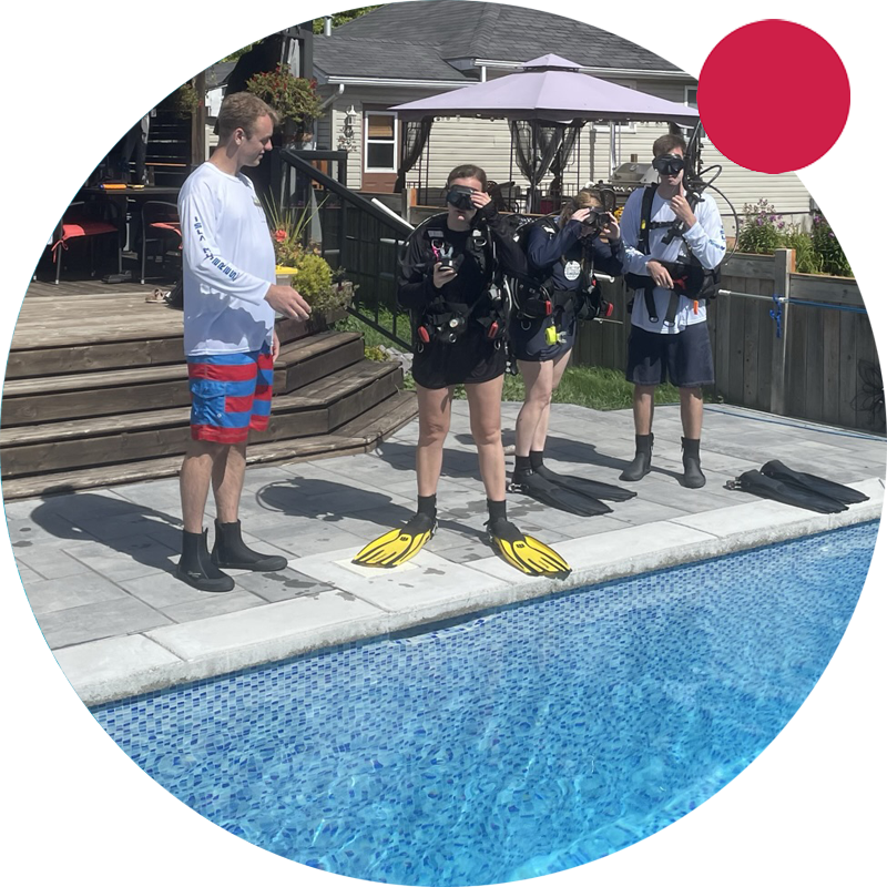 Kids waiting by pool with scuba instructor at Double Down Divers.